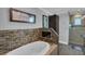 Elegant bathroom featuring a soaking tub with mosaic tile surround and a walk-in glass shower at 12312 Lagoon Ln, Treasure Island, FL 33706