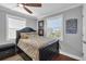 Comfortable bedroom with wood floors, a ceiling fan, and bright natural lighting at 12312 Lagoon Ln, Treasure Island, FL 33706