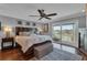 Spacious main bedroom with sliding glass doors to the balcony, hardwood floors, and neutral décor at 12312 Lagoon Ln, Treasure Island, FL 33706