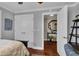 Bedroom featuring wood floors, closet, and view to adjacent hall and study at 12312 Lagoon Ln, Treasure Island, FL 33706