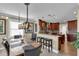 Dining room with a rustic table, pendant lighting, and a view into the kitchen at 12312 Lagoon Ln, Treasure Island, FL 33706