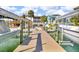 Waterfront home showcasing a dock for boating with boat lift access and backyard pool at 12312 Lagoon Ln, Treasure Island, FL 33706