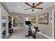 Bright exercise room featuring a modern ceiling fan, tiled floors, exercise bike, and sliding glass doors at 12312 Lagoon Ln, Treasure Island, FL 33706