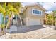 Two-story home featuring a neutral color palette, a two-car garage, and mature landscaping at 12312 Lagoon Ln, Treasure Island, FL 33706
