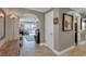 Interior hallway with tiled floors, arched doorway, and a view of the living room at 12312 Lagoon Ln, Treasure Island, FL 33706