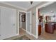 Hallway leading to kitchen showcasing tiled floors and white doors with views of the kitchen at 12312 Lagoon Ln, Treasure Island, FL 33706