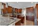 Well-equipped kitchen with granite counters, wood cabinets, and stainless steel appliances at 12312 Lagoon Ln, Treasure Island, FL 33706