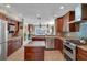 Well-equipped kitchen with island, granite countertops, stainless appliances, and tile backsplash at 12312 Lagoon Ln, Treasure Island, FL 33706