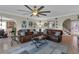 Open-concept living room with comfortable seating, stylish decor, and a large ceiling fan at 12312 Lagoon Ln, Treasure Island, FL 33706