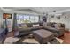 Cozy living room featuring a sectional sofa, hardwood floors, and a large window at 12312 Lagoon Ln, Treasure Island, FL 33706