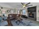 Spacious living room features a fireplace, TV, and comfortable seating with a view of the waterfront at 12312 Lagoon Ln, Treasure Island, FL 33706