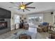 Cozy living room featuring a fireplace, comfortable seating, and a sliding glass door overlooking the waterfront at 12312 Lagoon Ln, Treasure Island, FL 33706