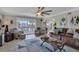 A waterfront living room featuring a brown leather sofa, stylish decor, and sliding glass doors to a balcony at 12312 Lagoon Ln, Treasure Island, FL 33706