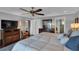 Comfortable main bedroom with a ceiling fan, natural lighting, and a view of the ensuite bathroom at 12312 Lagoon Ln, Treasure Island, FL 33706