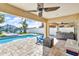 Inviting backyard with pool, patio, hot tub, palm trees and waterfront view; an ideal outdoor oasis at 12312 Lagoon Ln, Treasure Island, FL 33706