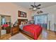 This bedroom has a large mirror, soft lighting, and a sliding glass door to the backyard at 1301 Flaxwood Ave, Brandon, FL 33511