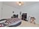 Spacious bedroom featuring tile floors and a dedicated workstation area with gaming PC setup at 1301 Flaxwood Ave, Brandon, FL 33511