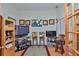 Cozy den with wood floors, two tv's, comfortable seating, and ample storage space at 1301 Flaxwood Ave, Brandon, FL 33511