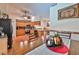 Open-concept dining area and kitchen featuring tile flooring, wooden cabinets, and stainless steel appliances at 1301 Flaxwood Ave, Brandon, FL 33511