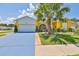 Charming single Gathering home with a well manicured yard, mature trees and a blue driveway at 1301 Flaxwood Ave, Brandon, FL 33511