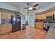 Bright kitchen featuring tile floors, wooden cabinetry, stainless steel appliances, and mosaic tile backsplash at 1301 Flaxwood Ave, Brandon, FL 33511