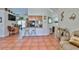 An open kitchen featuring tile floors, a breakfast bar with barstools, and views of the living room at 1301 Flaxwood Ave, Brandon, FL 33511