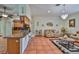 Open-concept living room with tile floors, a breakfast bar, chandelier, and seating area with leather couches at 1301 Flaxwood Ave, Brandon, FL 33511