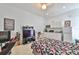 Living space features a kitchenette, gaming area, and bed at 1301 Flaxwood Ave, Brandon, FL 33511