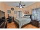 This primary bedroom features a workstation, soft lighting, and a ceiling fan at 1301 Flaxwood Ave, Brandon, FL 33511