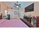 View of the main bedroom showcasing closet, tv, decor, and doorway to en suite at 1301 Flaxwood Ave, Brandon, FL 33511