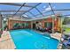 Inviting screened-in pool with an adjacent patio and comfortable outdoor seating area at 1301 Flaxwood Ave, Brandon, FL 33511