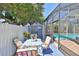 View of the screened in pool and backyard featuring a shed, patio and outdoor furniture at 1301 Flaxwood Ave, Brandon, FL 33511