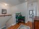 Hallway with an entryway into bedroom, small green desk, and hardwood floors at 1304 Kelridge Pl, Brandon, FL 33511