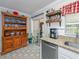 Bright kitchen with patterned tile floor, custom hutch, stainless steel appliances, and granite counters at 1304 Kelridge Pl, Brandon, FL 33511