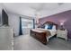 Spacious main bedroom with purple accent wall, ceiling fan, and decorative furnishings at 1304 Kelridge Pl, Brandon, FL 33511