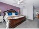Main bedroom with plush carpet, ornate headboard, and view of closet at 1304 Kelridge Pl, Brandon, FL 33511