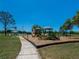 Colorful community playground featuring slides and climbing structures, surrounded by a wood chip safety surface at 1304 Kelridge Pl, Brandon, FL 33511