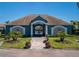 Community pool house entrance with decorative columns, gated access, and manicured landscaping at 1304 Kelridge Pl, Brandon, FL 33511
