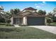 Charming single-Gathering home featuring a well-maintained lawn, covered entrance, and a two-car garage at 13180 Papercraft Ave, Brooksville, FL 34614