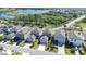 Aerial view of several two-story homes with garages, driveways, and lawns near a scenic lake and wetlands at 13319 Dorado Shores Ave, Riverview, FL 33579