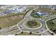 Aerial shot of a roundabout with palm trees, showcasing the community's landscaping and infrastructure at 13319 Dorado Shores Ave, Riverview, FL 33579