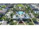 Aerial view of community pool, clubhouse, and gazebo surrounded by homes and lush landscaping at 13319 Dorado Shores Ave, Riverview, FL 33579