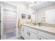 Updated bathroom showcasing bright vanity, mirror, and shower/tub combo at 13319 Dorado Shores Ave, Riverview, FL 33579