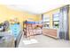 Cheerful yellow bedroom with bunk beds, natural light, and charming blue accents at 13319 Dorado Shores Ave, Riverview, FL 33579