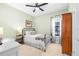 Cozy bedroom featuring a queen bed, ceiling fan, and a neutral color palette at 13319 Dorado Shores Ave, Riverview, FL 33579