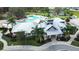 Aerial view of the neighborhood clubhouse with large pool, tennis courts, and lounge areas at 13319 Dorado Shores Ave, Riverview, FL 33579