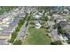 Aerial view of a community park, featuring a playground, picnic area, and gazebo, nestled among homes at 13319 Dorado Shores Ave, Riverview, FL 33579
