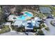 Aerial view of the community center with a pool, clubhouse, tennis courts, and well-maintained landscaping at 13319 Dorado Shores Ave, Riverview, FL 33579