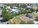 Aerial view of a community pool and playground, surrounded by lush greenery and residential homes at 13319 Dorado Shores Ave, Riverview, FL 33579