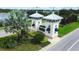 Community entrance sign with decorative towers, landscaping, and a view of the lake at 13319 Dorado Shores Ave, Riverview, FL 33579